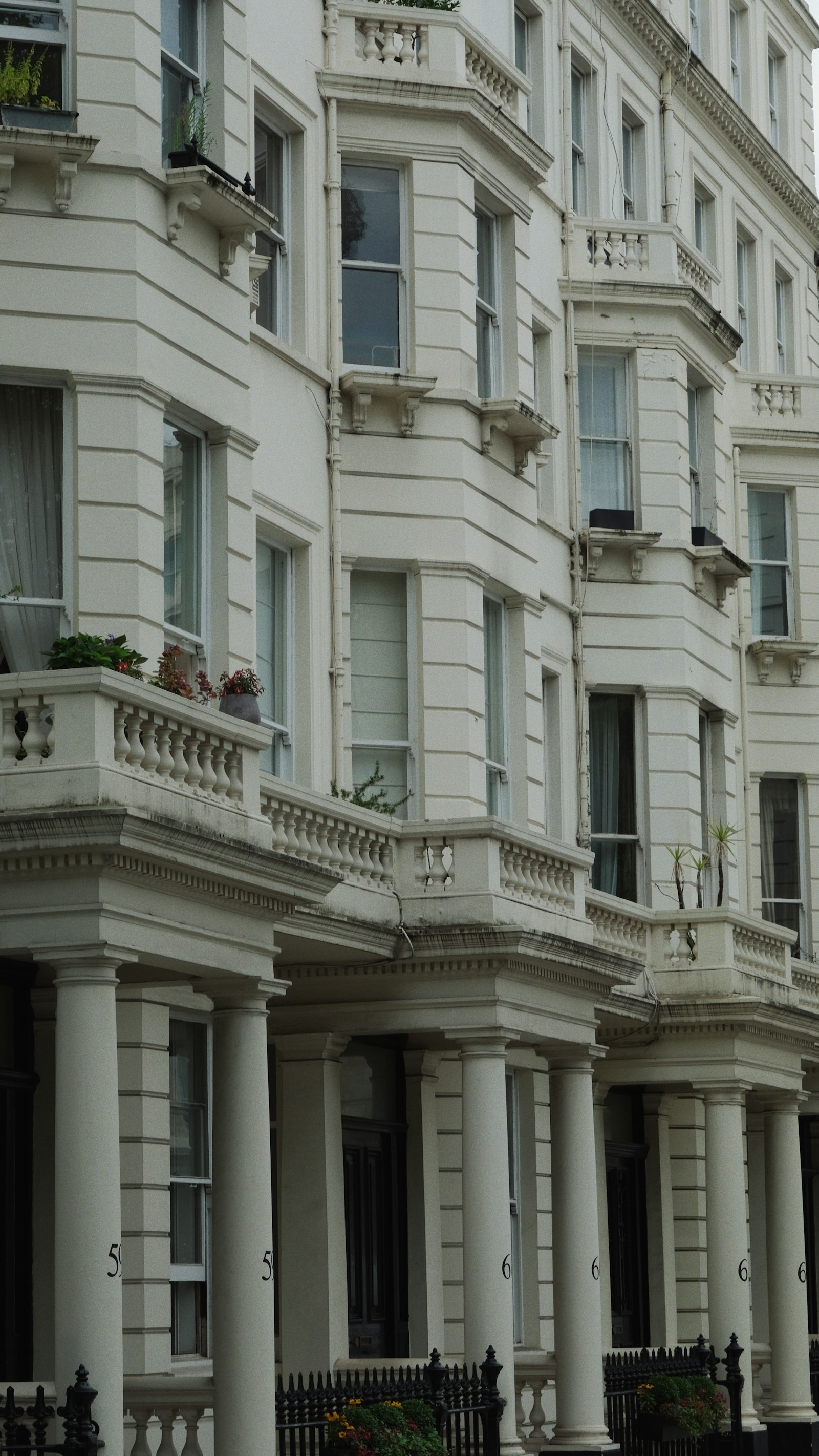 A white stucco London building with balconies